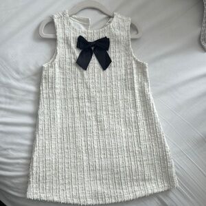 Elegant White Sleeveless Dress with Black Bow